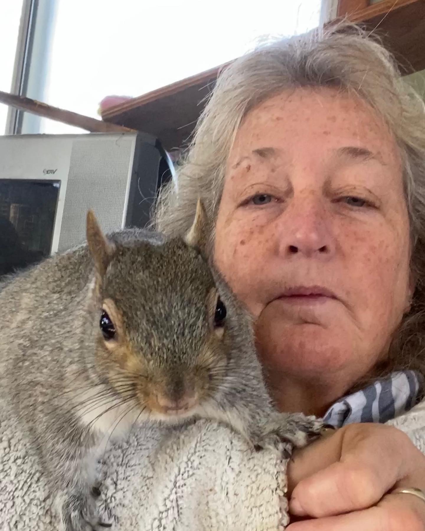 patty robinson posing for a selfie with bunk the squirrel. 
