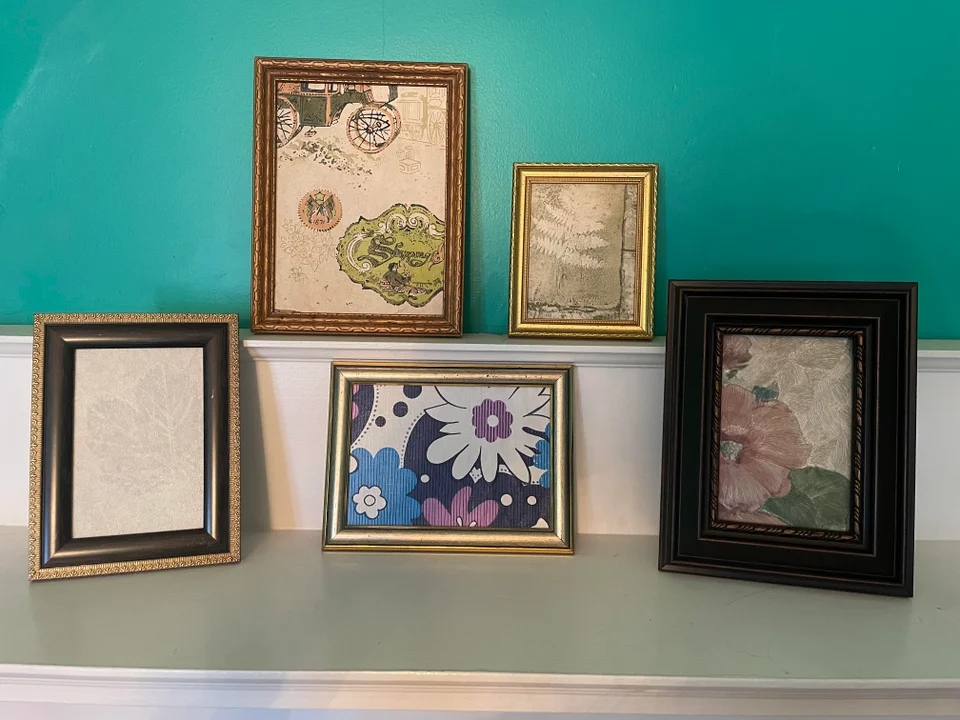 framed pieces of old wallpaper