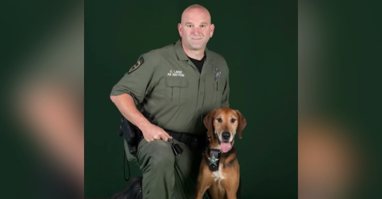 a hillsborough county sheriff’s office police officer posing for a photo with canine toby.
