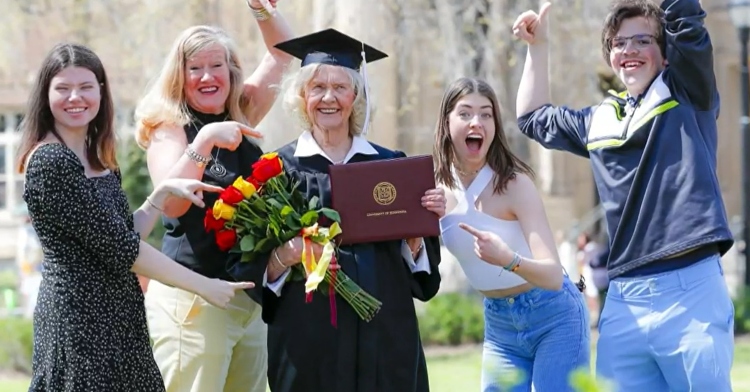 betty sandison wearing her graduation gown and celebrating with her family