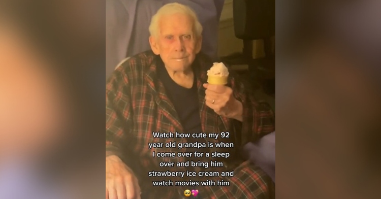 92-year-old man smiling as he holds an ice cream cone. the image is captioned with “watch how cute my 92-year-old grandpa is when I come over for a sleep over and bring him strawberry ice cream and watch movies with him.”