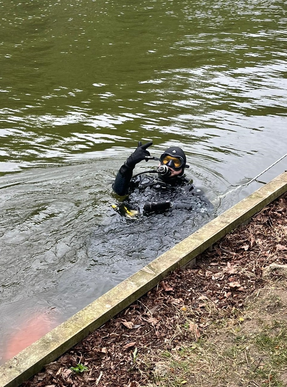 Matt Peters is in the water after finding the lost ring.
