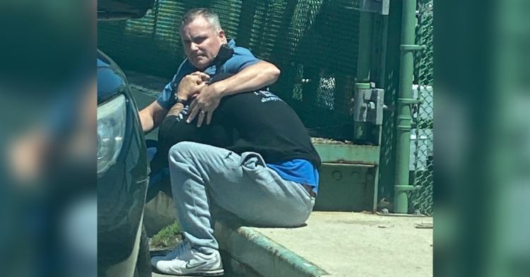 a cop consoling a man in distress