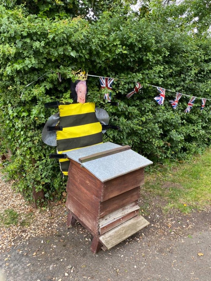 scarecrow of queen elizabeth dressed as a bee.