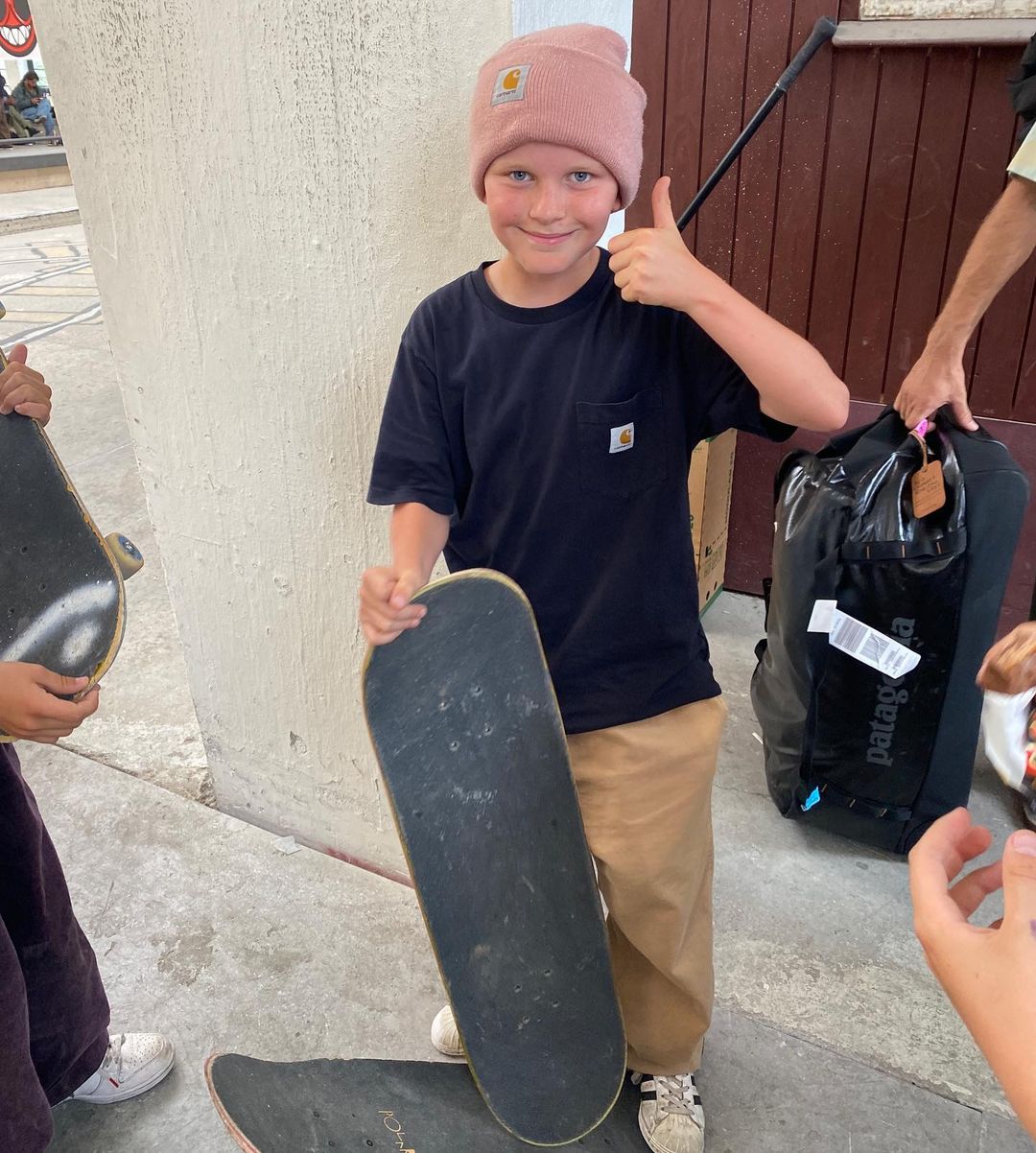 smiling kid with surfboard