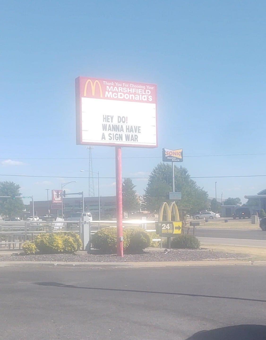 McDonald's sign that says "hey dq! wanna have a sign war"