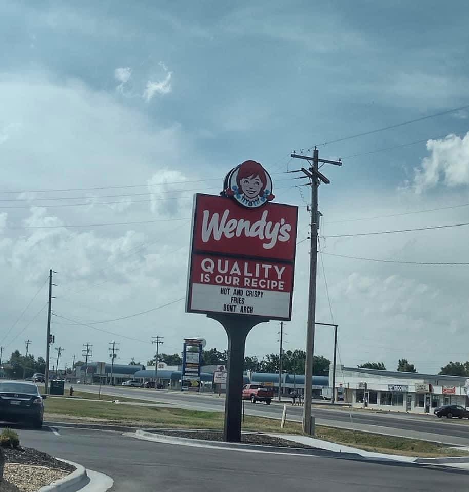 wendy's sign that says "hot and crispy fries, don't arch"