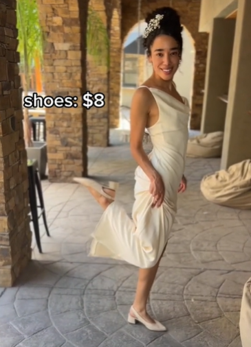 Jillian Lynch modelling her wedding dress and shoes on her wedding day, kicking one leg up behind her.