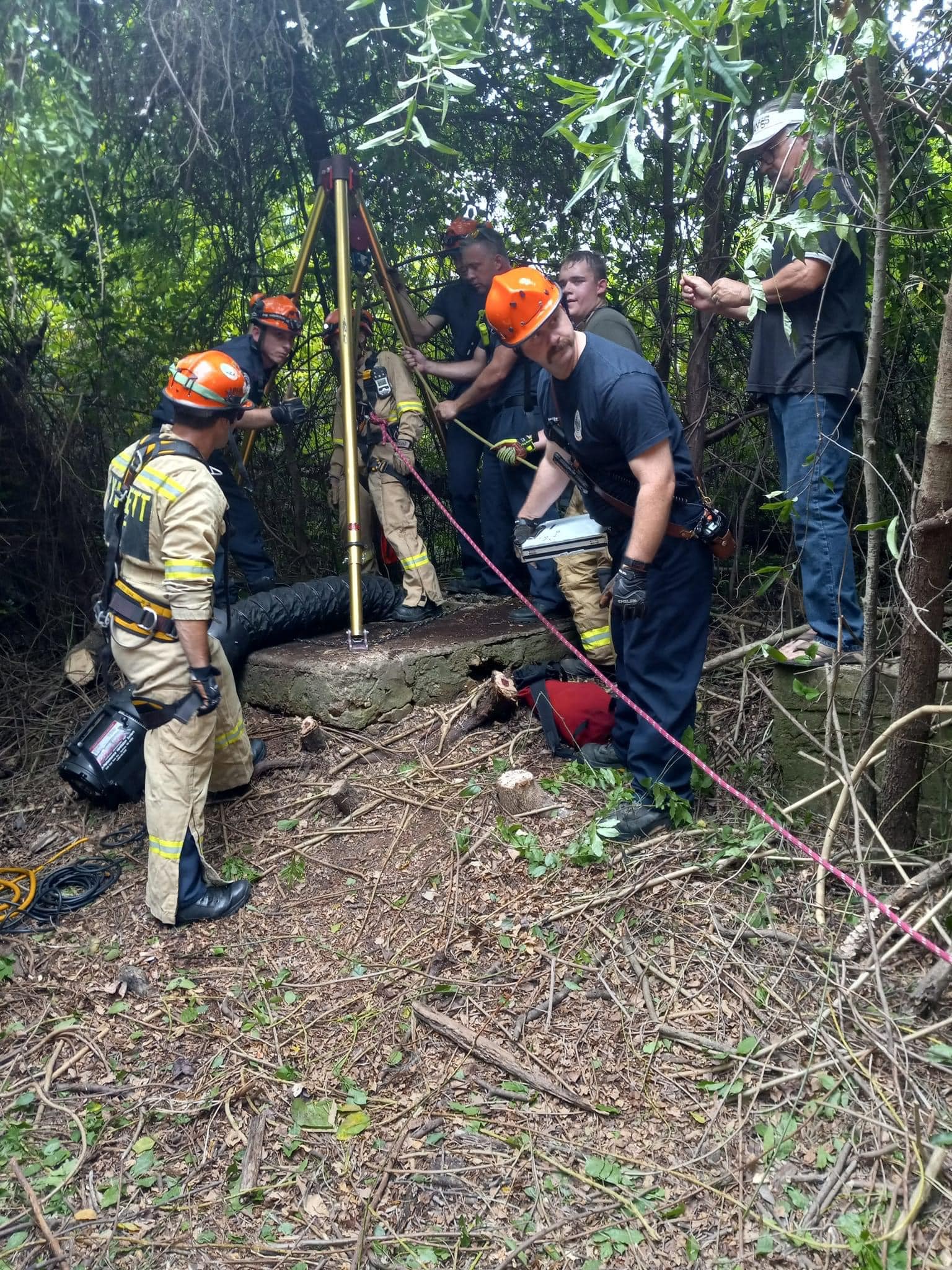 firefighters remove debris from well to rescue dog who fell down inside