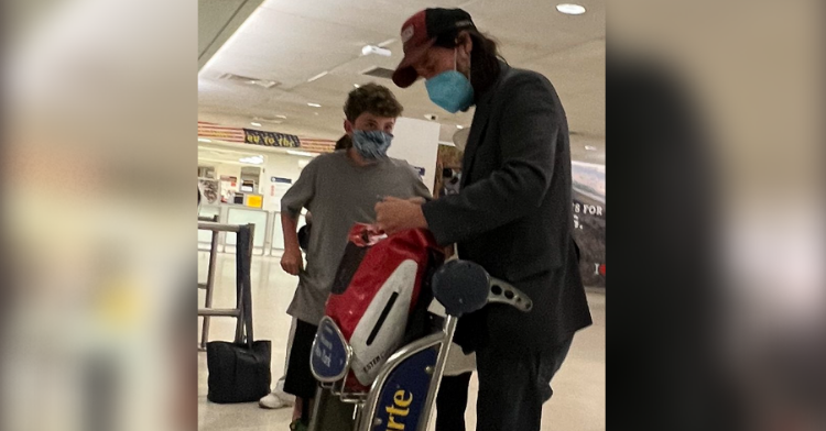 keanu reeves and little boy talking at the nyc airport.