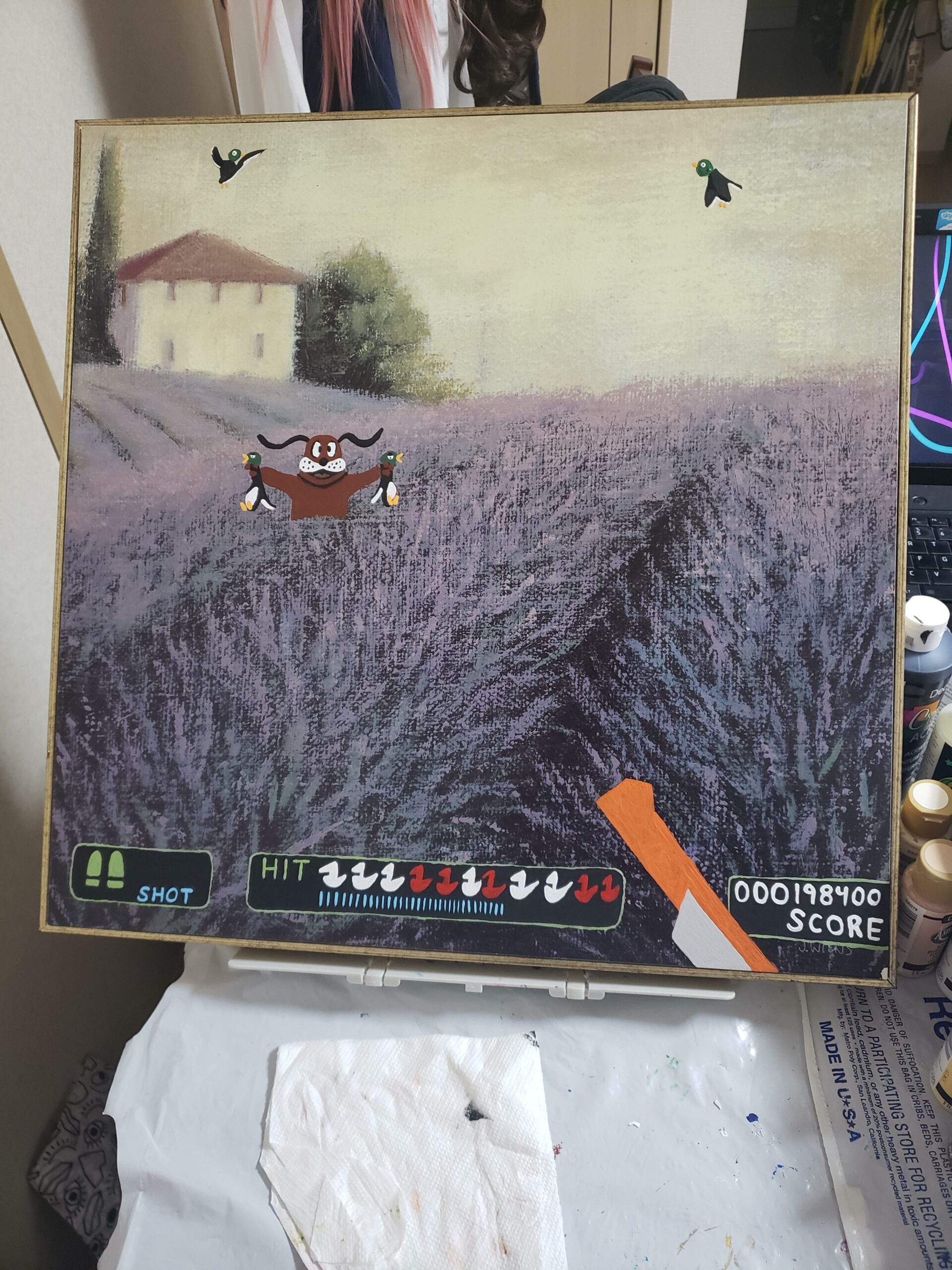 painting of a field of purple flowers with a two-story white house in the background. the duck hunt dog has been added in the middle of the flowers and is holding two ducks in his hands. two ducks are flying in the sky. the bottom of the painting has been made to replicate the duck hunt video game.