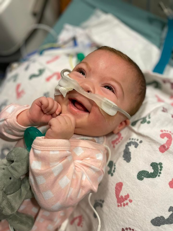 Charlotte Valliere smiling in hospital while connected to oxygen