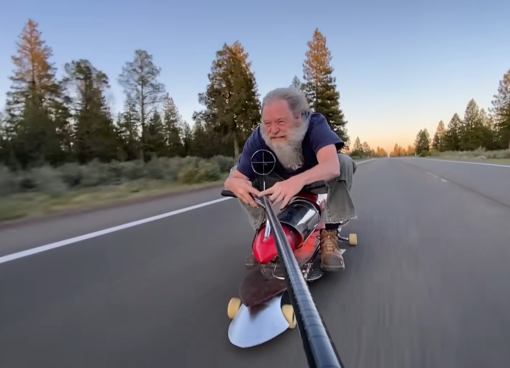 Bob Maddox riding a jet-propelled skateboard he invented.