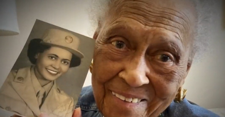 102-year-old Romay Davis holds photo of herself as a young woman