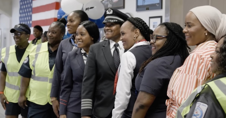 line of nine black women in aviation posing for a photo at american airlines.