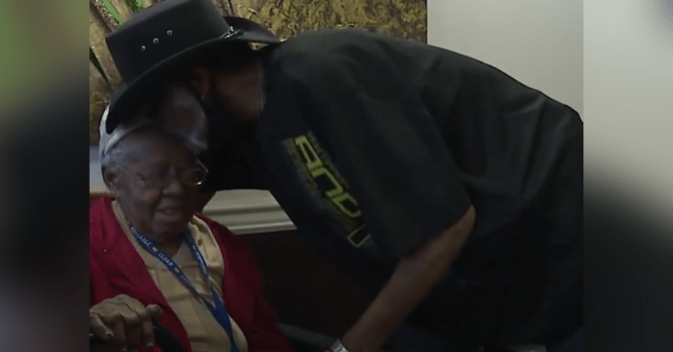 cowboy kissing elderly neighbor on the forehead