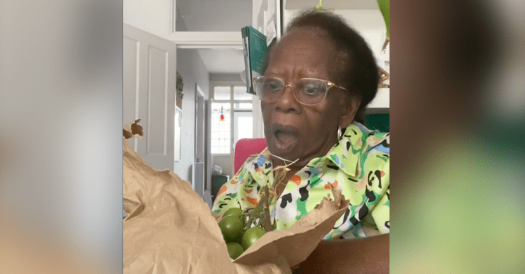 kali's great-grandmother looking surprised when she sees what is inside the bag.