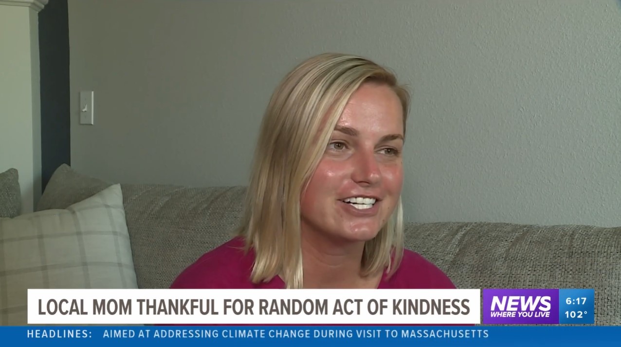 devon linden smiling as she talks with the local news about the kind stranger who gave her $100 and a note. the bottom of the image is the title of the news story: "local mom thankful for random act of kindness."