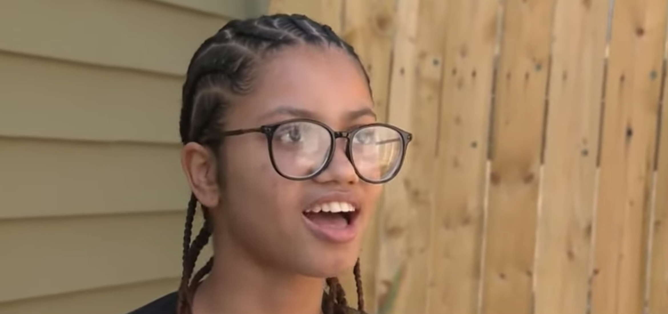 closeup of savennah mendes-rodrigues talking as she stands outside and in front of a fence.