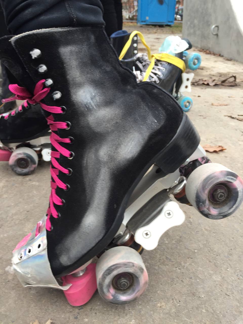 black rollerblades with a dusty white outline on them that looks like a skeleton foot x-ray