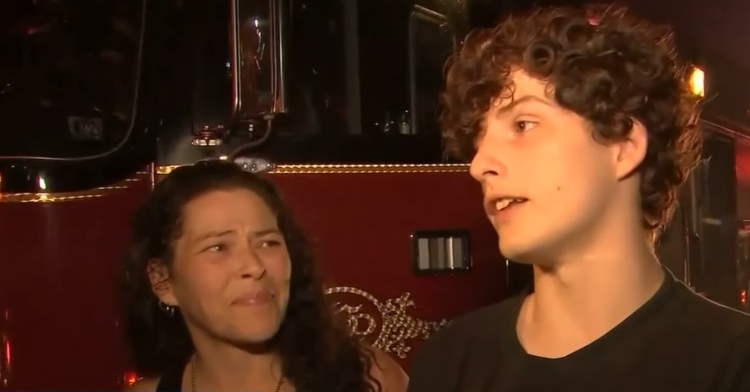 falon o'regan talking to the local news as his mom stands next to him, almost in tears as she watches him.