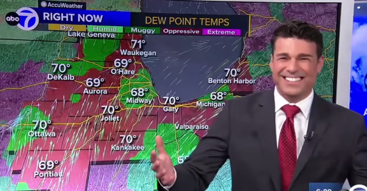meteorologist greg dutra smiling at the camera and standing in front of his touchscreen weather monitor.