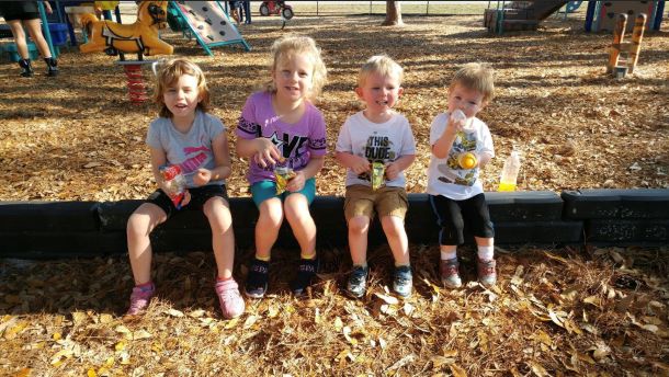 Children sitting at a playground.