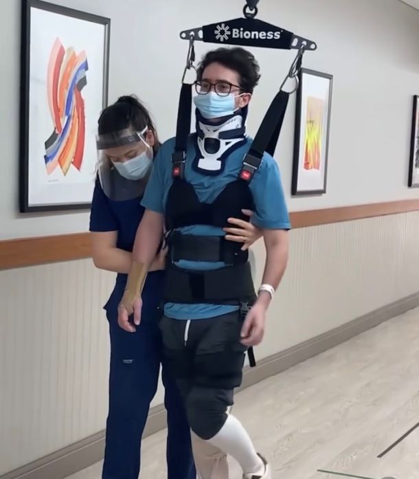 Chase being assisted in therapy harness at the hospital.