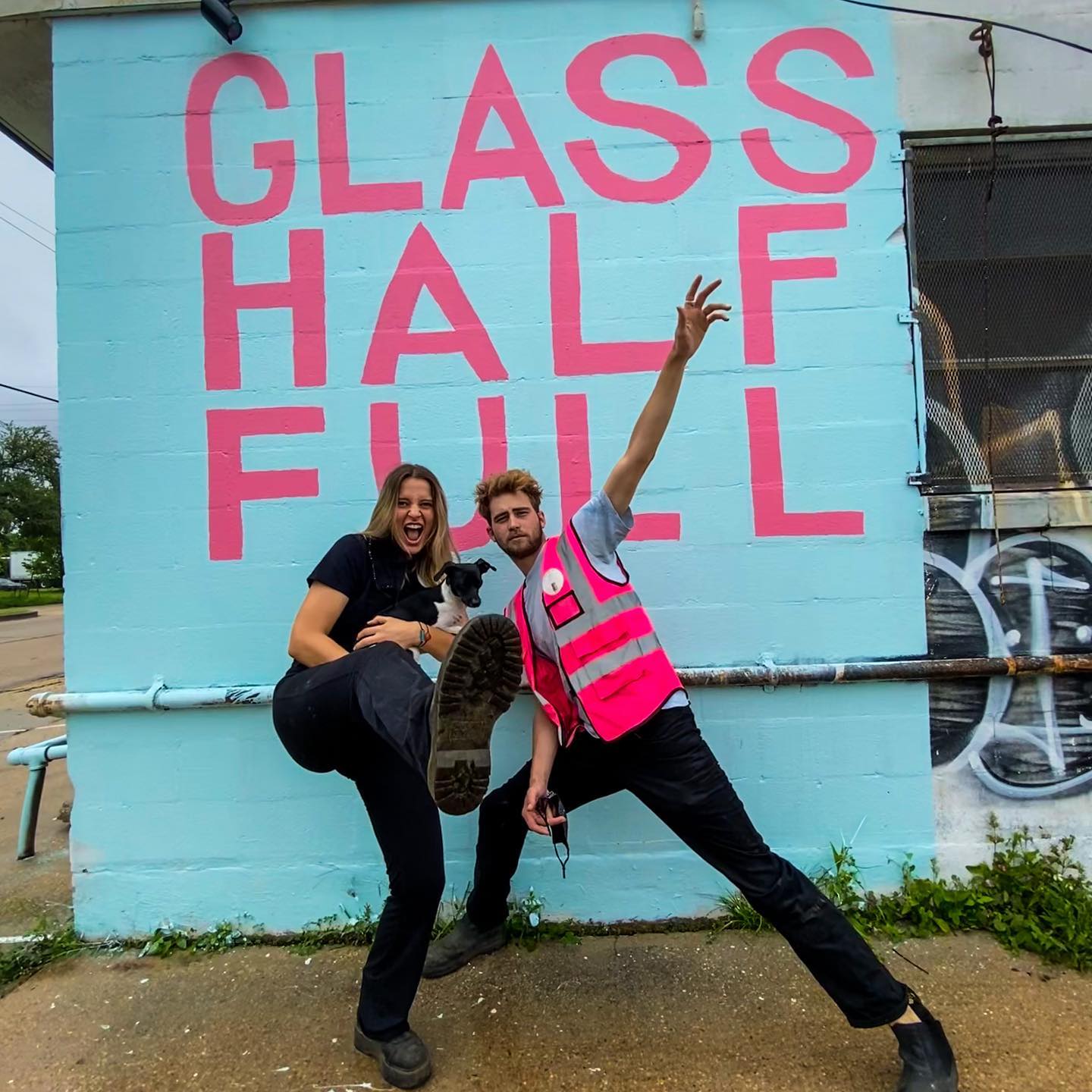 Franziska Trautmann and Max Steitz strike a pose in front of the Glass Half Full recycling center.