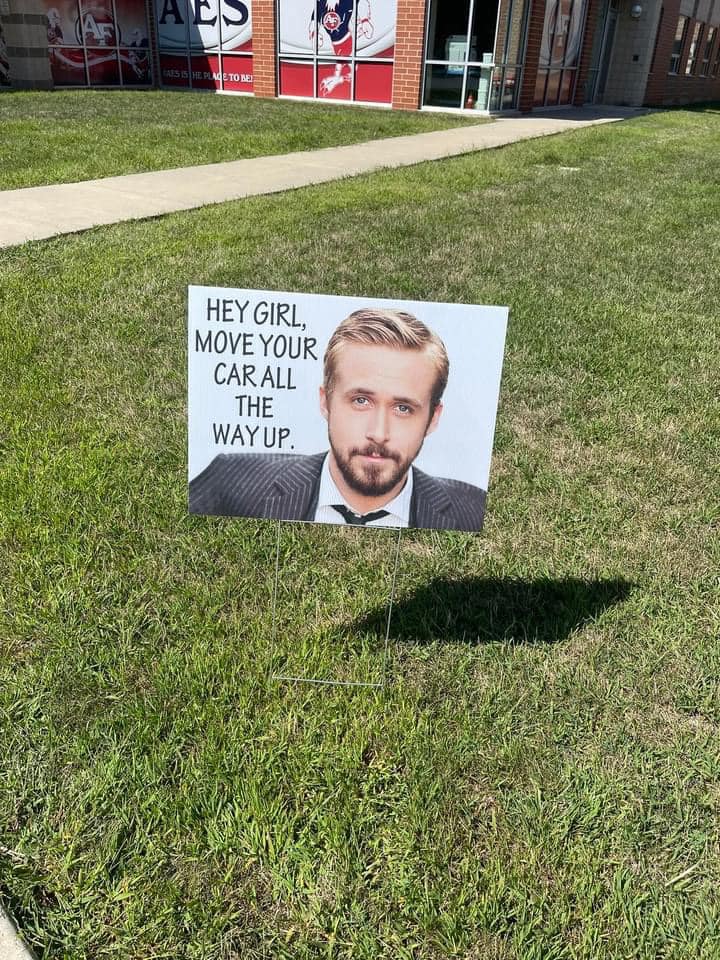 funny PTA sign with Ryan Gosling's face and words "Hey girl, move your car all the way up."