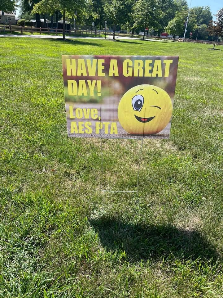 funny PTA sign with a winking emoji and the words "Have a great day, love AES PTA"