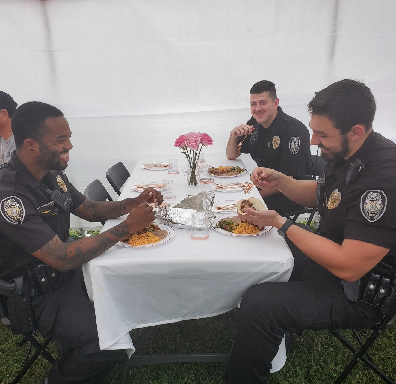 greensboro police officers smiling while eating at a quinceaÃ±era party