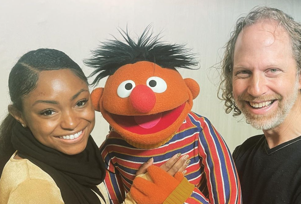megan peace holding ernie the muppet and peter linz who plays ernie's character