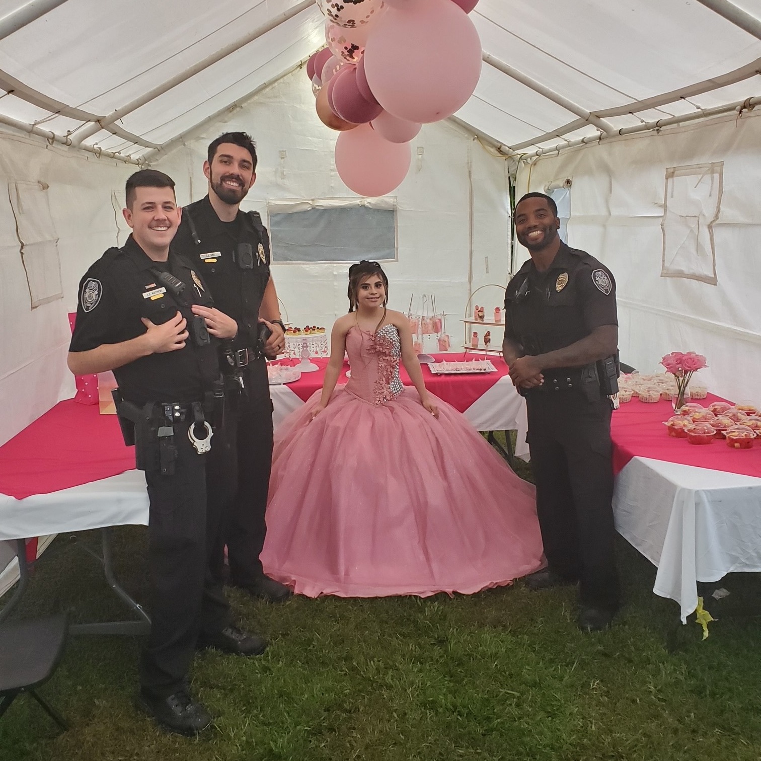greensboro police department officers smiling and standing next to the quinceaÃ±era