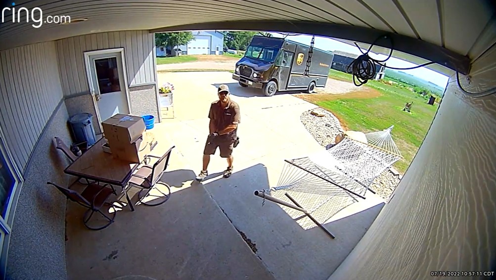 Colin Mitchell as soon from Jeff and Rebecca Marra's Ring doorbell camera. He's walking toward their front door. His UPS truck is parked in the driveway.