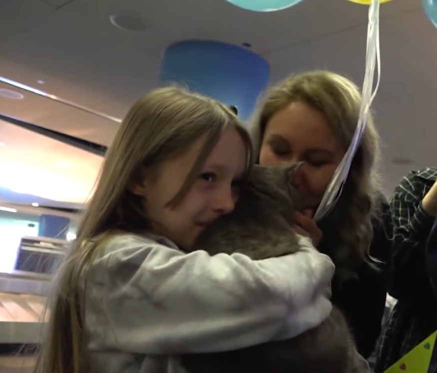 Agnessa and Maria hugging Arsenii the cat