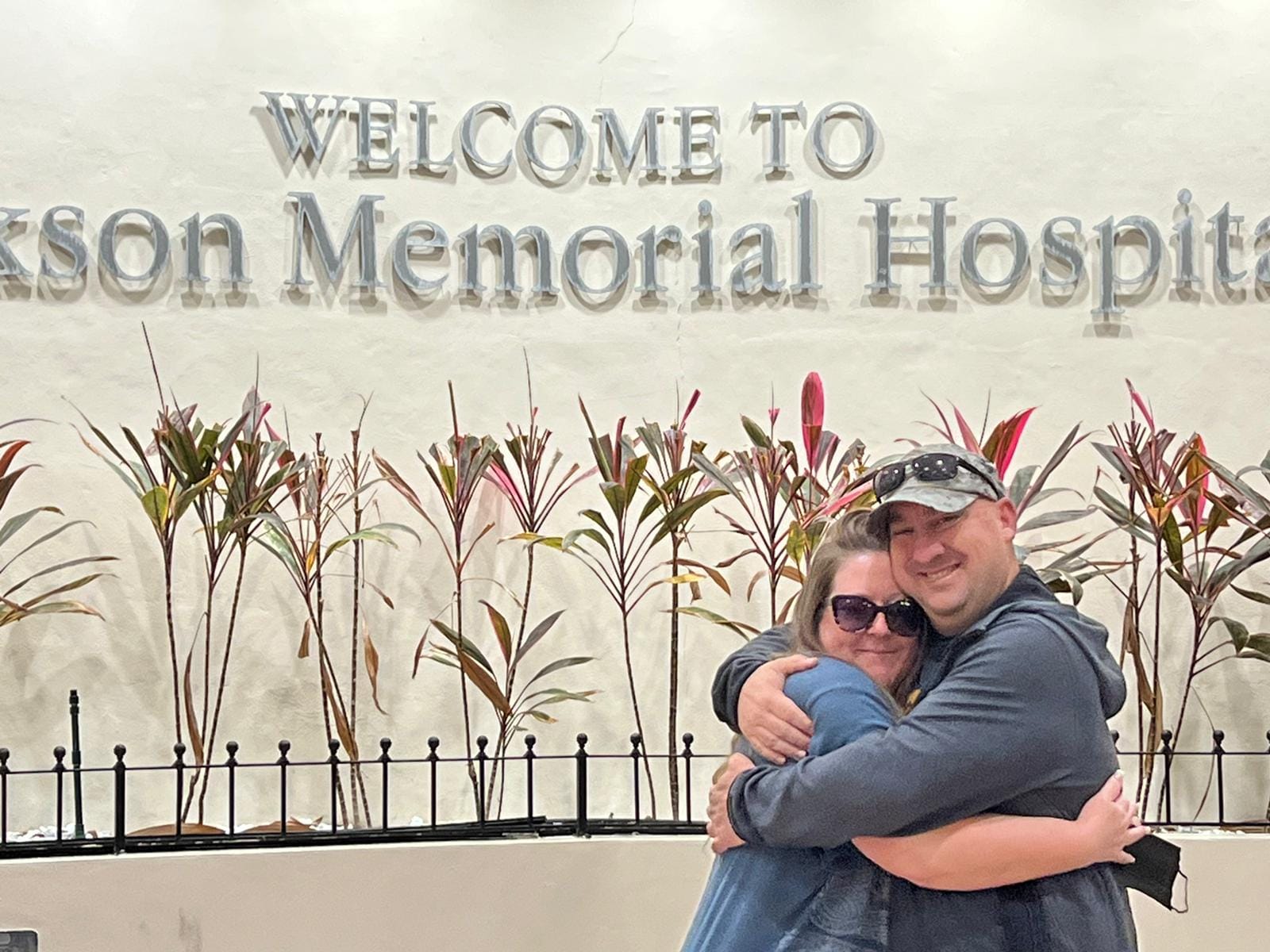Dawn Martin and Jeff Hackman hug outside Jackson Memorial Hospital. 
