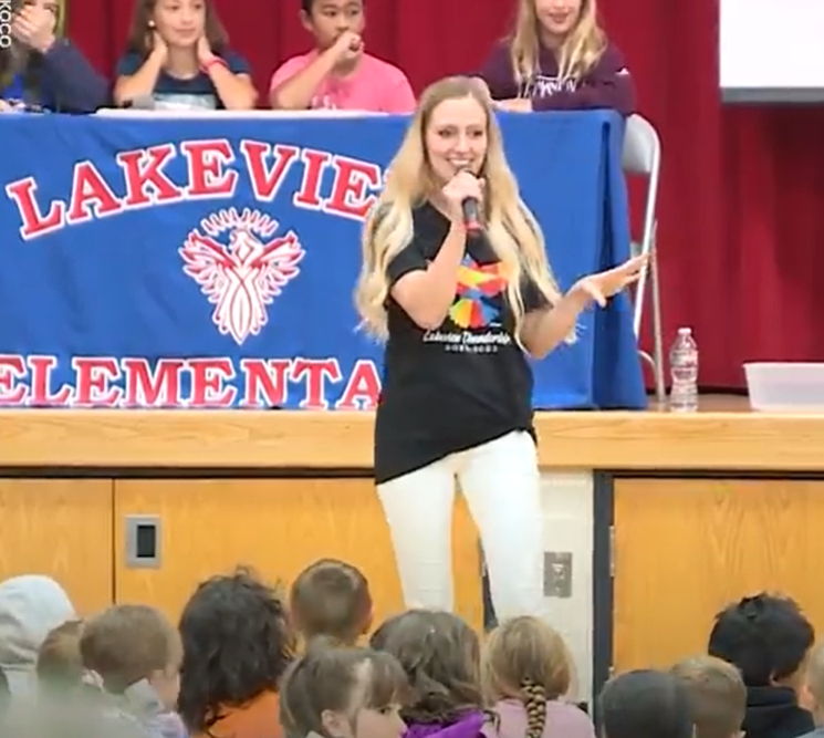 music teacher Jordan Nguyen leads assembly at Lakeview Elementary School in Norman, OK