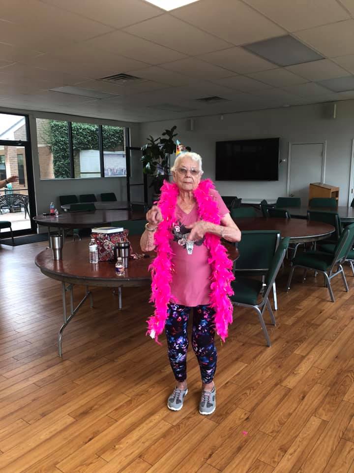 Margaret Masters wearing a pink feathered boa during Zumba class