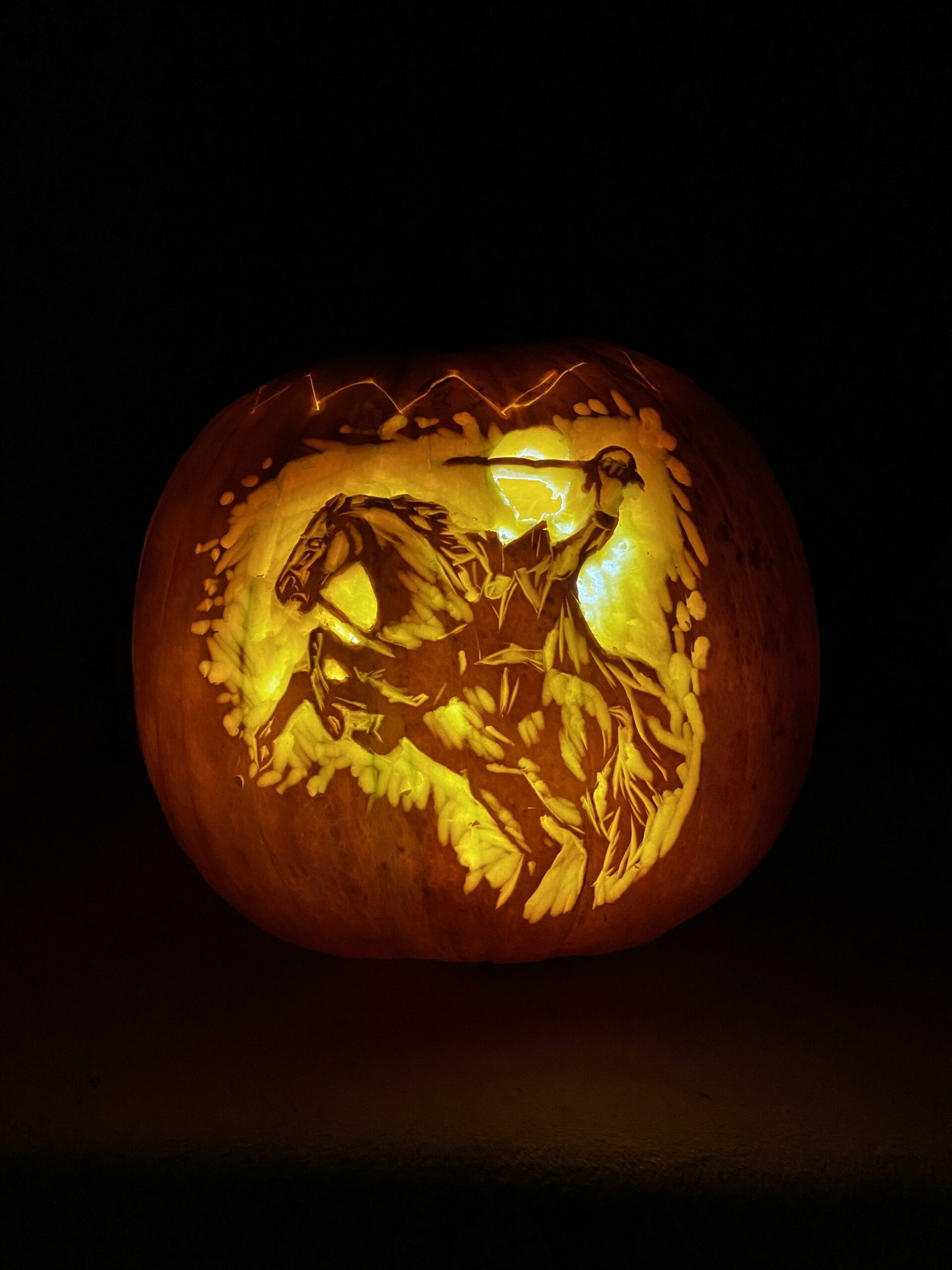 pumpkin carved with Headless Horseman design