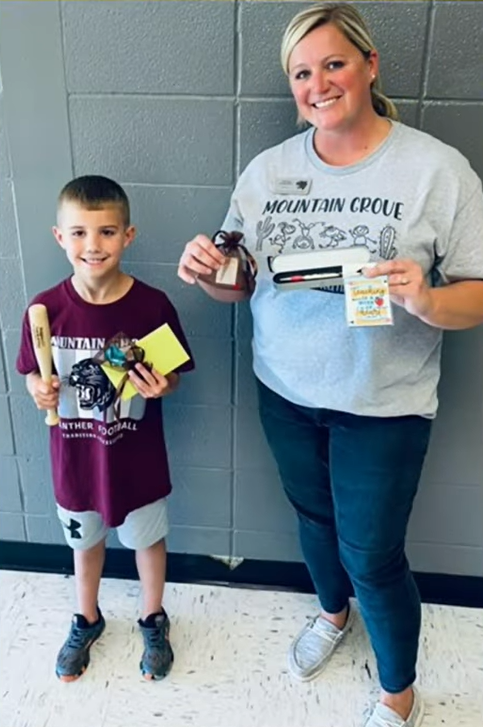 Kason Johnson and his teacher show off their gifts from Todd Huyley