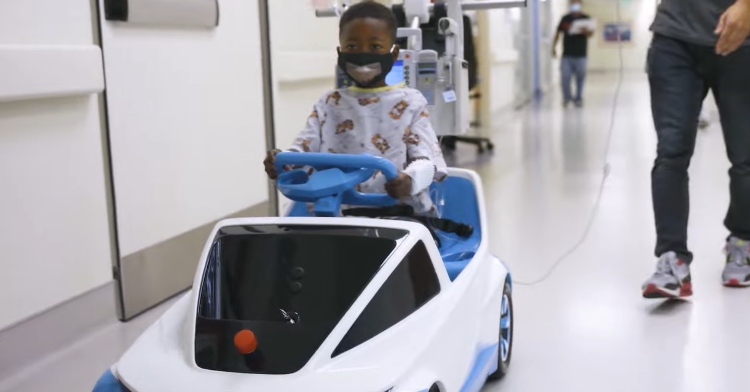 little boy drive Shogo, an electric car made by Honda