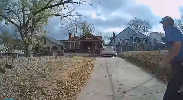 Police officer running toward a house.