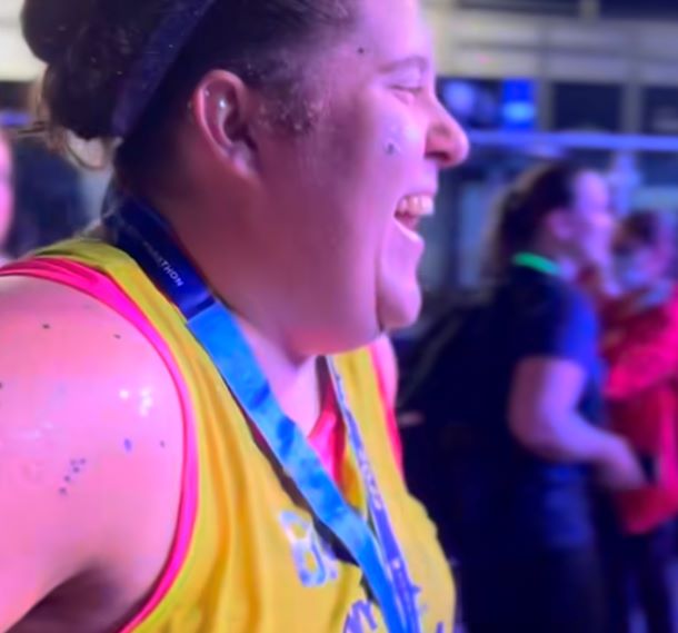 A marathon participant smiles as she finishes the race.