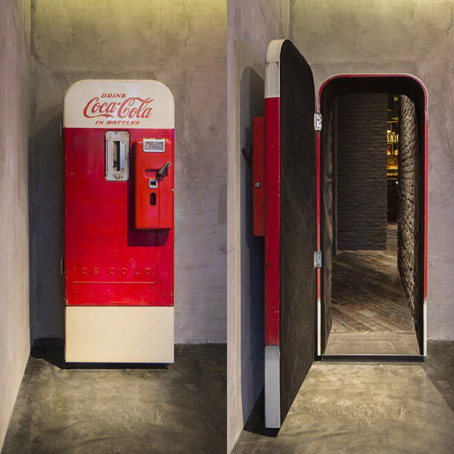 hidden passageway behind an old fashioned Coke machine