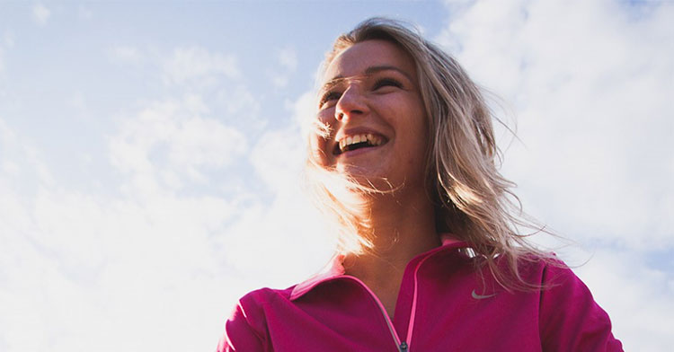 woman looking off into the distance and smiling