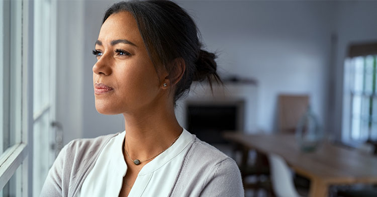 woman looking thoughtfully out window