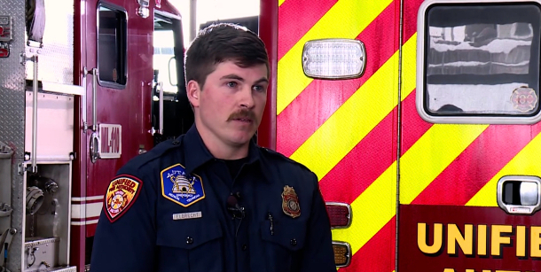 Tom speaks at the fire station as he recalls the rescue mission to save a skier. 