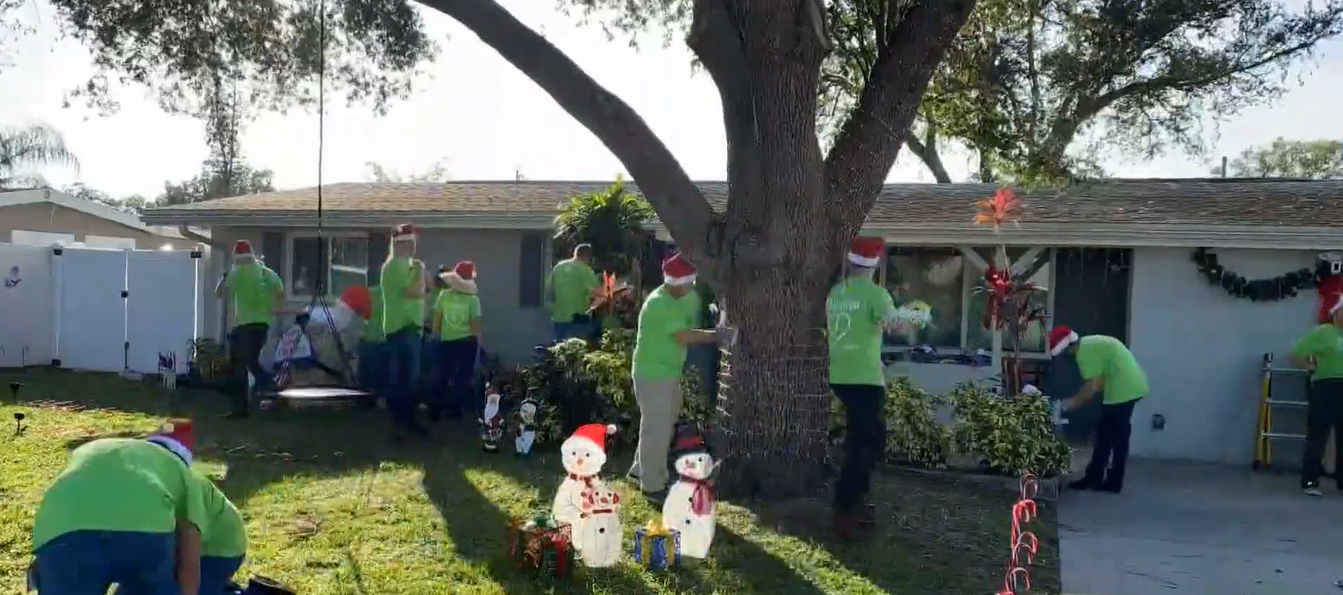 FPL elves decorating Carlos Moreira's house in Florida.
