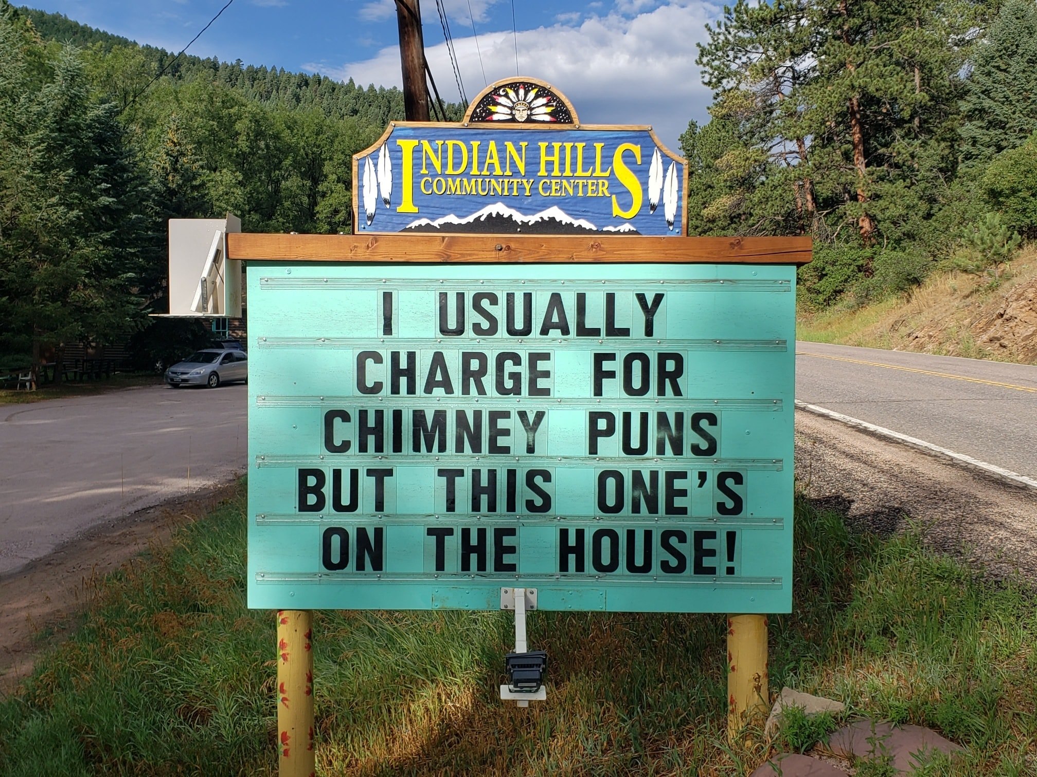 community sign that says: "I usually charge for chimney puns but this one's on the house."